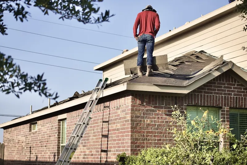 Professional roofer working on a residential roof in Sutherlin